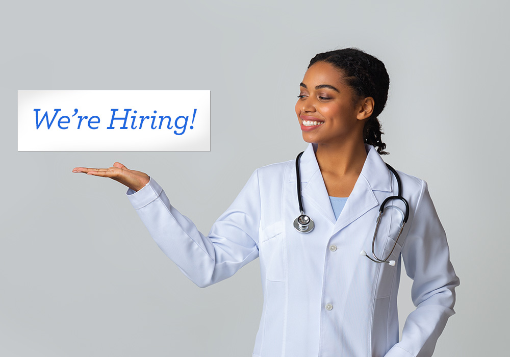 A woman smiles next to a floating "We're hiring!" banner.