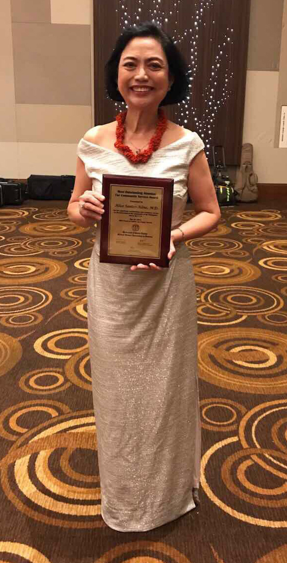 alice alino md with national service award plaque